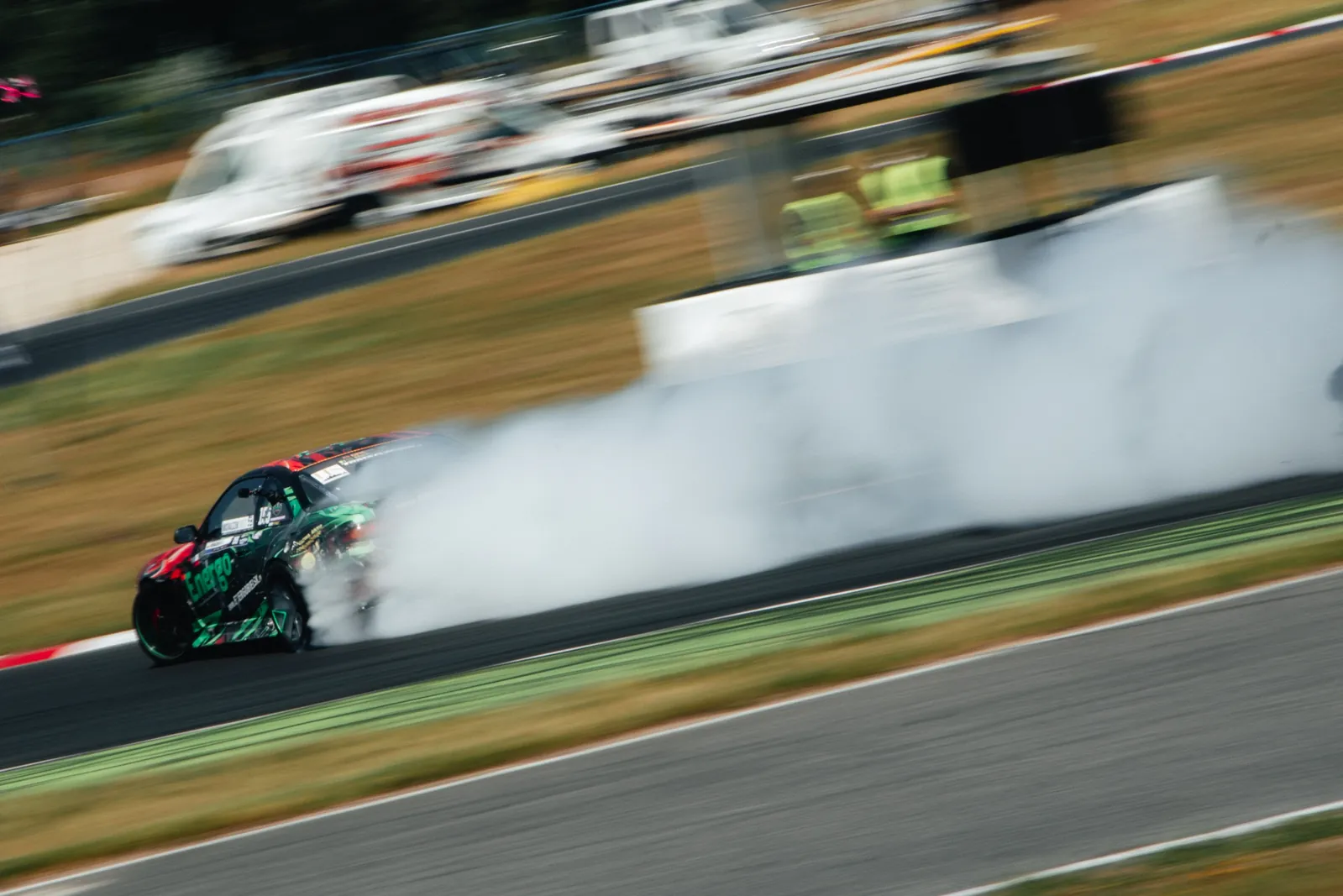 Drift car moving through smoke on track