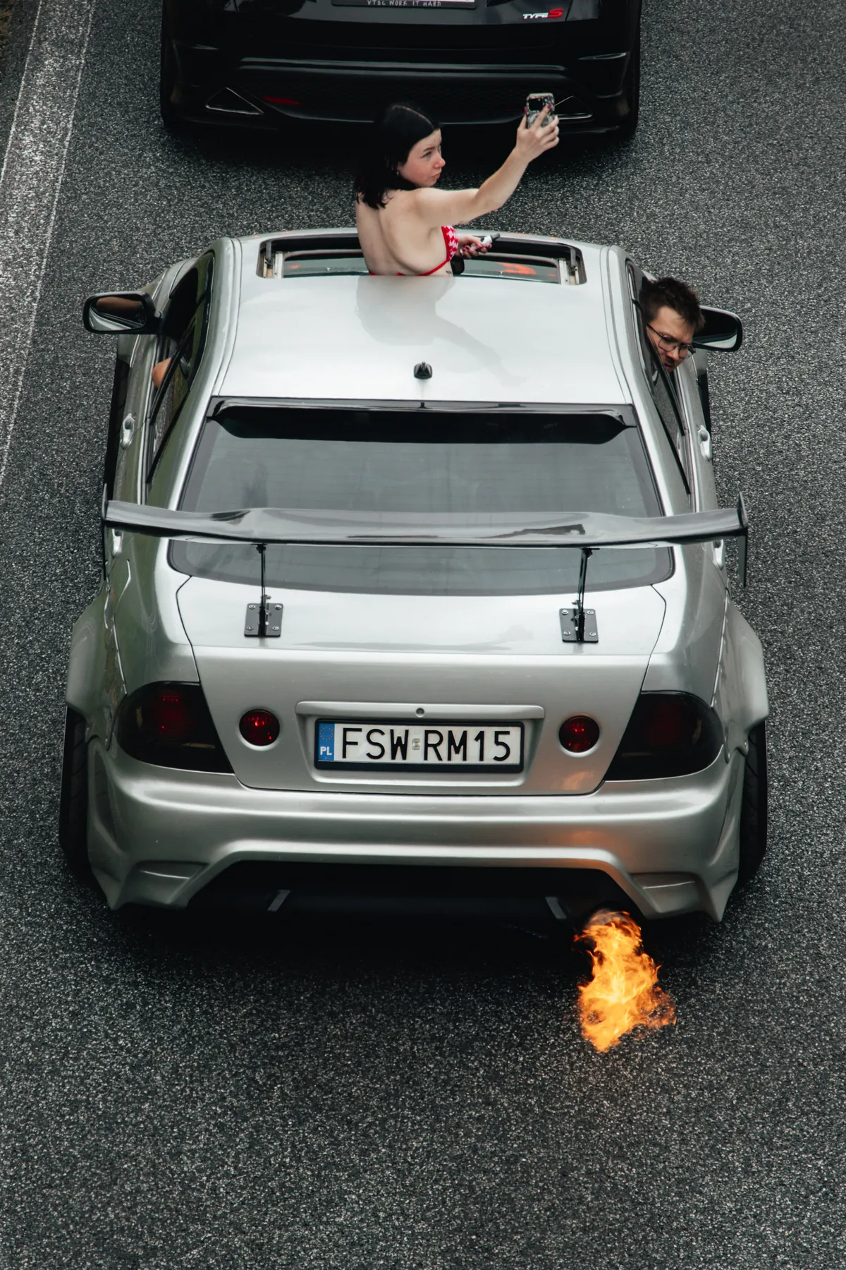 Modified car seen from above with a flame from its exhaust