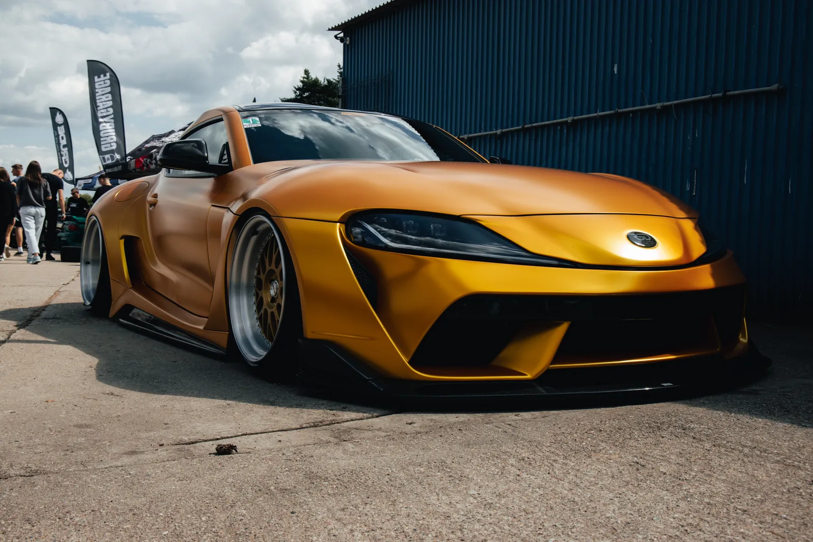 Yellow sports car at a motorsport event