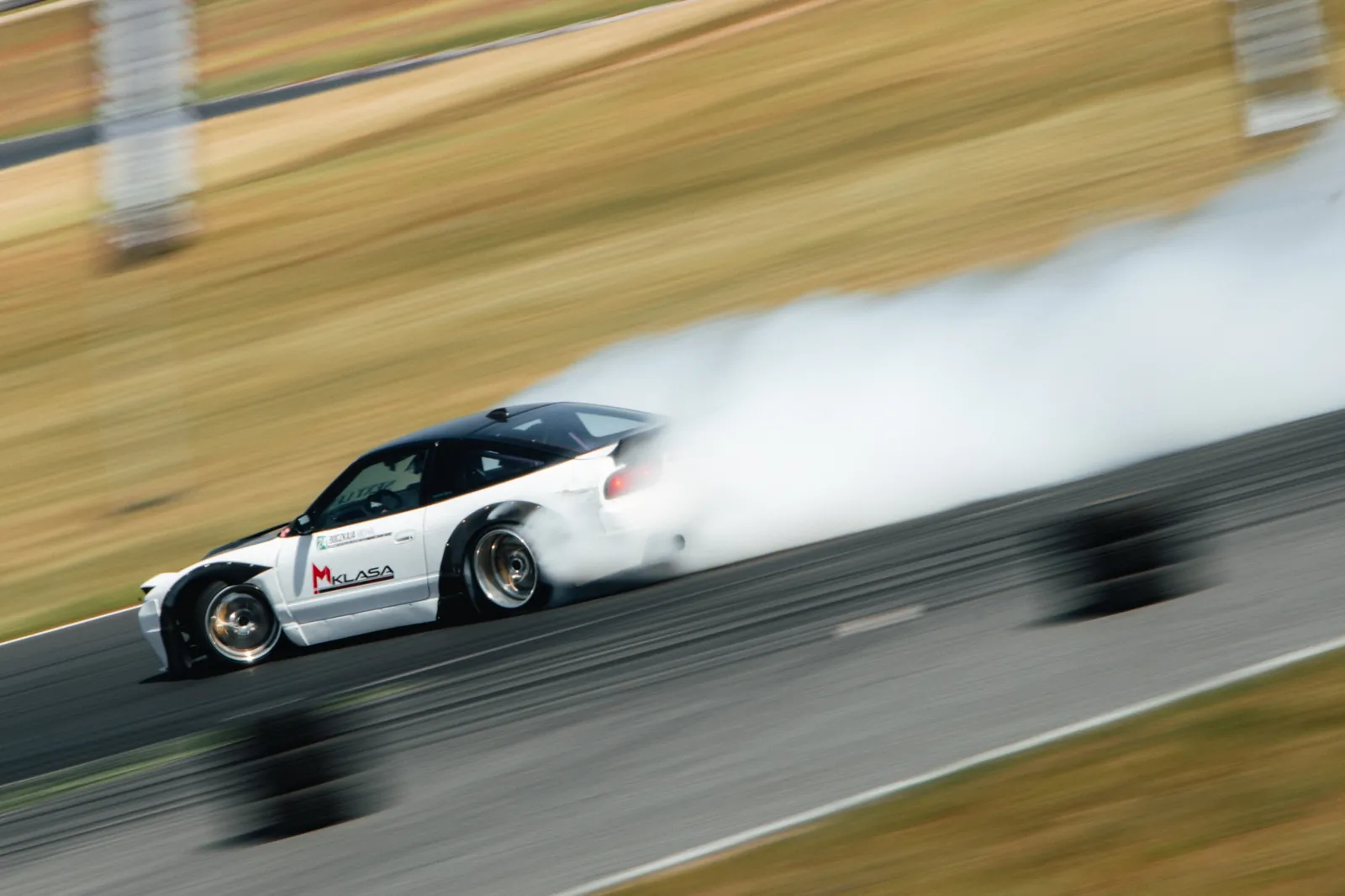 Drift car on track in a cloud of smoke