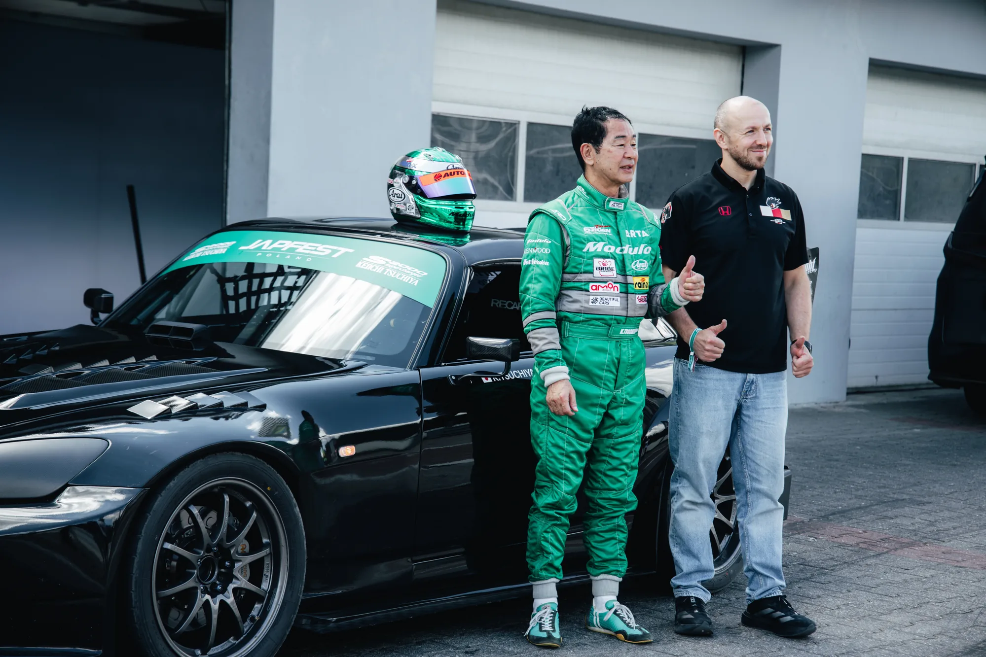 Driver and team member in the paddock